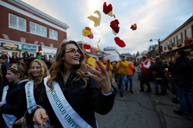 Rose petals are scattered as a wheel of Crucolo cheese, from Trentino, Italy, is carried to the Concord Cheese Shop for the Christmas holiday season during the seventh annual Crucolo Parade in Concord, Massachusetts, U.S. December 1, 2016. (Photo by Brian Snyder/Reuters)