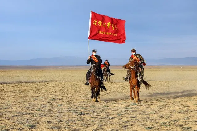 This photo taken on April 22, 2021 shows police officers and a staff member riding horses as they prepare to publicise laws and government policy to nomad herders in a remote area in Altay in China's northwestern Xinjiang region. (Photo by AFP Photo/China Stringer Network)