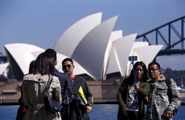 File picture of Chinese tourists taking pictures of themselves as they pose in front of the Sydney Opera House in Sydney, Australia, September 28, 2015. Australia is planning a A$40 million global tourism campaign to help fill the economic hole left by the commodities downturn, targeting a growing group of Chinese holidaymakers who favour independent itineraries over traditional large group packages. (Photo by David Gray/Reuters)