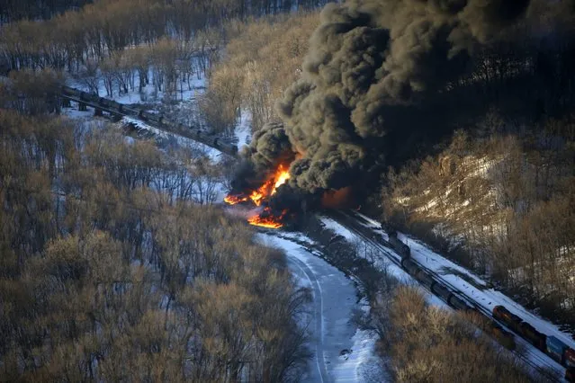 Smoke and flames erupt from the scene of a train derailment Thursday, March 5, 2015, near Galena, Ill. A BNSF Railway freight train loaded with crude oil derailed around 1:20 p.m. in a rural area where the Galena River meets the Mississippi, said Jo Daviess County Sheriff's Sgt. Mike Moser. (AP Photo/Telegraph Herald, Mike Burley)