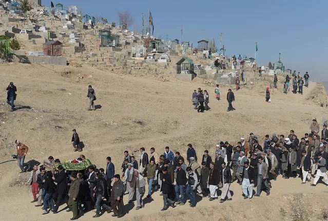 Afghan mourners carry the coffin of Saeed Jawad Hossini, 29, who was killed in a suicide attack on a minibus carrying employees of Afghan TV channel TOLO in Kabul on January 21, 2016. Seven employees of popular Afghan TV channel TOLO were killed on January 21 when a Taliban car bomber rammed into their minibus in Kabul, just months after the militants declared the network a legitimate “military target”. (Photo by Shah Marai/AFP Photo)