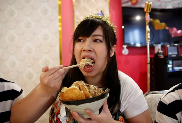 Michiko Ohashi, a member of pop group Pottya, has her meal at a fan meeting celebrating her birthday in Tokyo, Japan, October 16, 2016. Competition is cutthroat among Japan's thousands of pop idol wannabes, but a unique concept is winning fame for a band of “chubby” girls deploying their cheeky cuteness to combat prejudices against obesity. Despite one of the lowest rates of obesity in the developed world, Japan has a growing number of underweight young women, who rely on excessive dieting to satisfy society's emphasis on being slim. Heavy people are the frequent target of jokes in the media and use of the derogatory “debu”, or “fatso”, remains common. Enter “Pottya”, a pop group named after a slang word for chubby and consisting of four young women who are not especially hefty to Western eyes, but well above average weight in Japan. Members range in weight from 63 kg (139 lb) to 87 kg (192 lb) for the 26-year-old Ohashi, and their average of 76 kg (168 lb) is about 26 kg (57 lb) over the Japanese average for women aged 13 to 18, according to the Health Ministry. Their body mass index, which compares weight to height, ranges from 27.4 to 31.2. Doctors consider an individual with a BMI above 25 to be overweight, and one above 31 obese. Pottya has passionate devotees, both male and female, many of whom describe themselves as overweight. Fans gather to meet Pottya members for a high-calorie lunch each month, with the menu of one recent meal featuring rice, noodles, chicken and potatoes – all fried. (Photo by Kim Kyung-Hoon/Reuters)