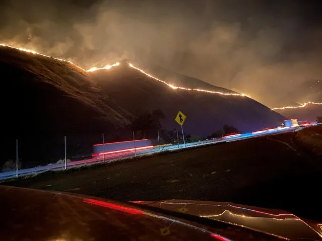 The Shell Fire burns vegetation on a hill along a highway in Kern County, California, U.S. June 27, 2021. (Photo by  @CaLandBird/Twitter via Reuters)