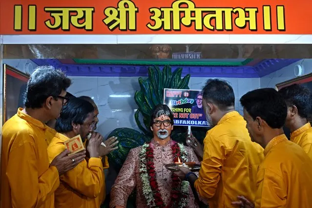 Fans and wellwishers of Bollywood actor Amitabh Bachchan offer prayers at a temple on the occasion of his 81st birthday in Kolkata on October 11, 2023. (Photo by Dibyangshu Sarkar/AFP Photo)