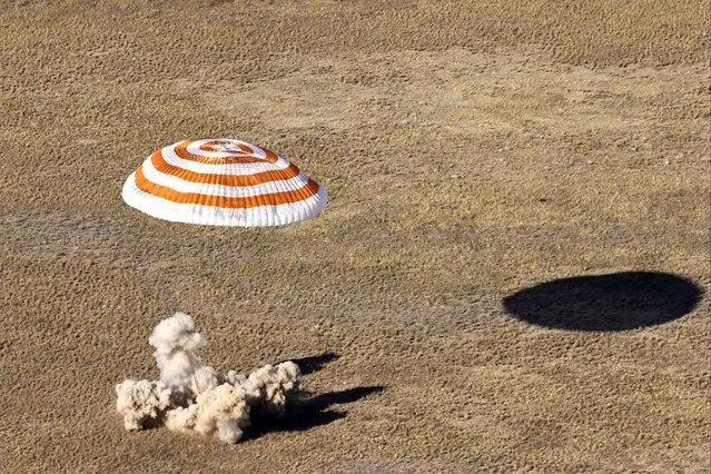 In this image distributed by Roscosmos State Space Corporation, the Russian Soyuz MS-21 space capsule lands southeast of the Kazakh town of Zhezkazgan, Kazakhstan, Thursday, September 29, 2022. Three Russian cosmonauts returned safely from a mission to the International Space Station. The Soyuz MS-21 spacecraft carrying Oleg Artemyev, Denis Matveyev and Sergey Korsakov touched down softly at 4:57 p.m. (1057 GMT) Thursday at a designated site in the steppes of Kazakstan about 150 kilometers (about 90 miles) southeast of the city of Zhezkazgan. (Photo by Pavel Kassin, Roscosmos State Space Corporation via AP Photo)