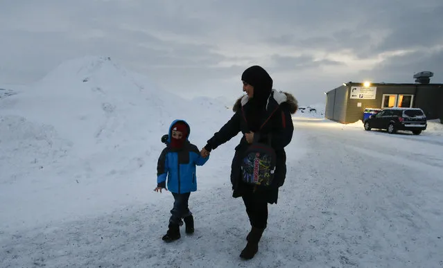 In this photo taken Thursday, February 4, 2016 in Hammerfest, northern Norway, refugee Huda al Haggar and her son Omar from Sanaa in Yemen talk to the Associated Press at the northernmost refugee camp in the world. Waiting for their asylum claims to be processed, hundreds of people in emergency shelters in Hammerfest and neighboring towns are slowly getting used to the extreme climate and unfamiliar customs of the High North. (Photo by Alastair Grant/AP Photo)
