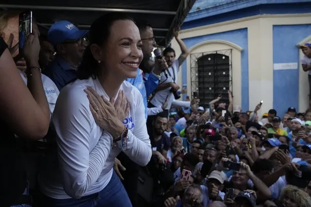 Opposition presidential hopeful Maria Corina Machado gestures to supporters during a rally in Valencia, Carabobo state, Venezuela, Thursday, October 5, 2023. The opposition will hold a primary on Oct. 22. (Photo by Ariana Cubillos/AP Photo)