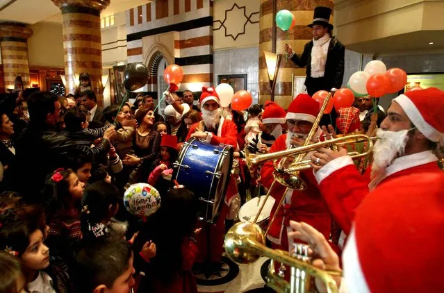 Christians celebrate Christmas during a party held at the Dama Rose hotel in Damascus, Syria on Wednesday, December 25, 2013. (Photo by AP Photo)