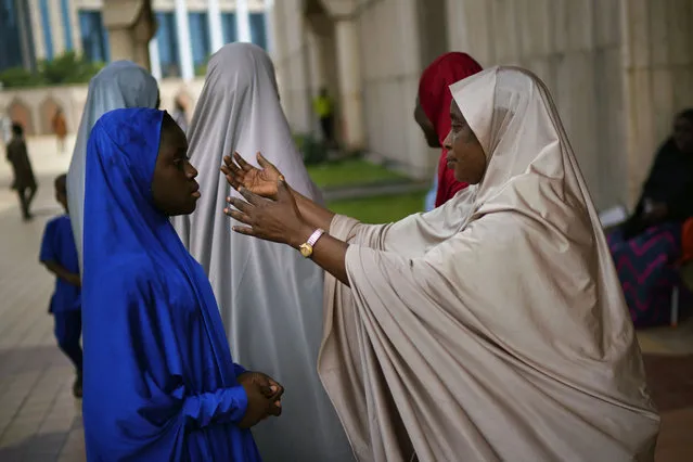 A Nigerian woman attends Friday prayers at the central mosque is security checked a day prior to the election, in Abuja, Nigeria, Friday February 15, 2019.  Nigeria surged into the final day of campaigning ahead of Saturday's election, as President Muhammadu Buhari made one last pitch to stay in office while top challenger Atiku Abubakar shouted to supporters: “Oh my God! Let them go! Let them go”! (Photo by Jerome Delay/AP Photo)