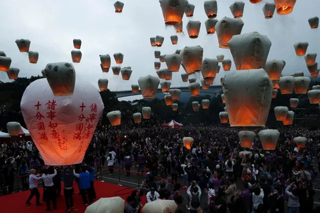 People release sky lanterns to celebrate the traditional Chinese Lantern Festival, marking the end of the Lunar New Year celebrations in Pingxi, New Taipei City, Taiwan on February 19, 2019. (Photo by Tyrone Siu/Reuters)