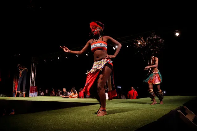 A model walks on a catwalk during a fashion show featuring African fashion and culture as part of a gala marking the launch of a book called “African Twilight: The Vanishing Rituals and Ceremonies of the African Continent” at the African Heritage House in Nairobi, Kenya on March 3, 2019. (Photo by Baz Ratner/Reuters)