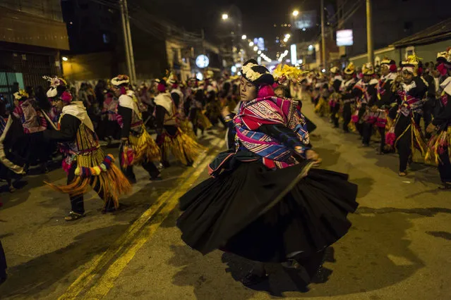 In this January 29, 2017 photo, dancers perform during Virgin of Candelaria celebrations in downtown Puno, Peru. The annual celebration is a rare moment of national focus on an indigenous-dominated village culture in Peru. (Photo by Rodrigo Abd/AP Photo)