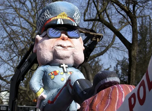 A carnival float with papier-mache caricatures featuring the leader of Polish Law and Justice party Jaroslaw Kaczynski oppressing Poland,is displayed at a postponed "Rosenmontag" (Rose Monday) parade, at one location in Duesseldorf, Germany, March 13, 2016, after the original parade in February was cancelled due to severe weather. (Photo by Ina Fassbender/Reuters)