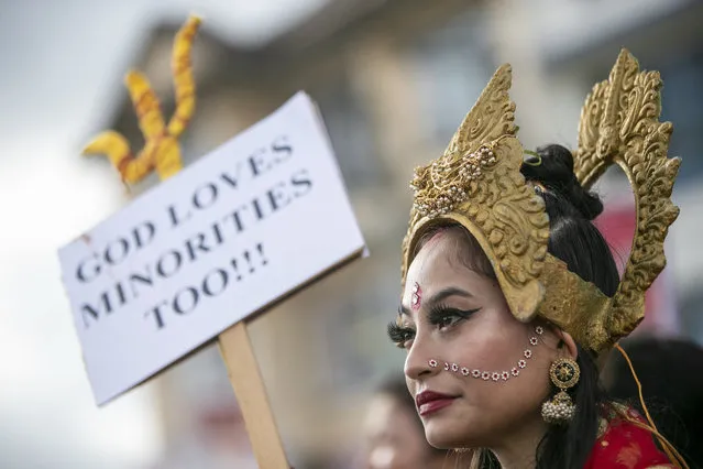 A member of ISKCON (International Society for Krishna Consciousness) participates in a peaceful protest against the recent violence against Hindus in Bangladesh and to demand protection of minorities outside Bangladeshi embassy in Kathmandu, Nepal, Wednesday, October 20, 2021. Hindu temples were attacked and homes of Hindus were burned in Bangladesh since last Wednesday after a photo was posted on social media showing a copy of Islamic holy book, the Quran, at the feet of a statue at a Hindu temple. (Photo by Niranjan Shrestha/AP Photo)