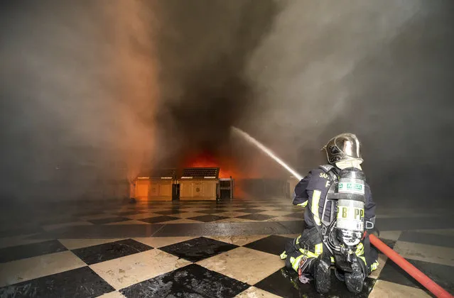 This photo provided Tuesday April 16, 2019 by the Paris Fire Brigade shows fire fighters spraying water inside Notre Dame cathedral, Monday April 15, 2019. An inferno that raged through Notre Dame Cathedral for more than 12 hours destroyed its spire and its roof but spared its twin medieval bell towers, and a frantic rescue effort saved the monument's “most precious treasures”, including the Crown of Thorns purportedly worn by Jesus, officials said Tuesday. (Photo by Benoit Moser/BSPP via AP Photo)