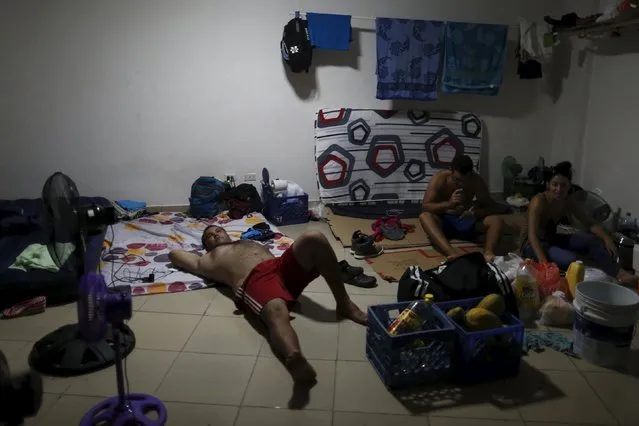 Cuban migrants rest in one of the rooms of an old hotel used as a provisional shelter in Paso Canoas, at the border with Costa Rica, in Panama March 21, 2016. (Photo by Carlos Jasso/Reuters)