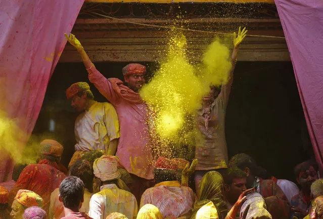 Hindu devotees throw coloured powder at each other as they celebrate “Lathmar Holi” at the village of Barsana in the northern Indian state of Uttar Pradesh March 9, 2014. (Photo by Anindito Mukherjee/Reuters)