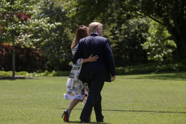 U.S. President Donald Trump and first lady Melania Trump walk together on the South Lawn as they depart for travel to Japan from the White House in Washington, U.S., May 24, 2019. (Photo by Leah Millis/Reuters)