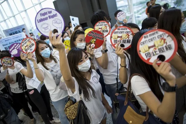 Cathay Pacific flight attendants participate in a protest at the departure hall of the Hong Kong Airport, China May 19,2015. Cathay Pacific Airways Flight Attendants Union started a sit in protest at the airport on Tuesday, after failed talks with management over pay and working conditions, local media reported. (Photo by Tyrone Siu/Reuters)