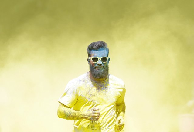 A participant runs through colored powder as he takes part in the Get Rainbowed run in Prague May 23, 2015. (Photo by David W. Cerny/Reuters)