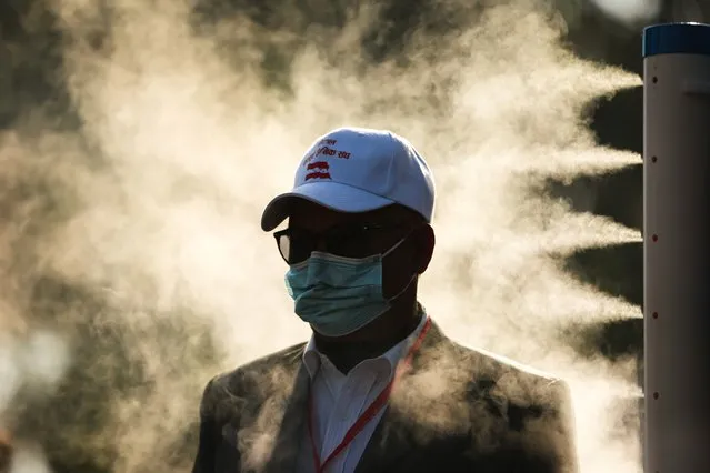A person is sprayed with disinfectants as he enters the main voting area of 14th General Convention of Nepali Congress in Kathmandu, Bagmati, Nepal on December 13, 2021. The marathon event of 4 days ends on Monday with voting to choose various officials including the Party President. (Photo by Amit Machamasi/ZUMA Press Wire/Rex Features/Shutterstock)