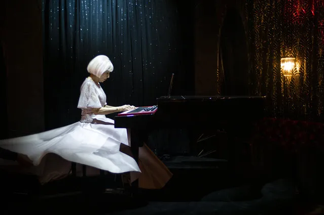 French artist Marie Beltrami plays piano during the shooting of a video presentation of French fashion designer Alexis Mabille Women's Fall/Winter 2021/2022 collection at Le Boeuf sur le Toit restaurant in Paris, France, 04 March 2021. Amid the Covid19 pandemic, the Paris Fashion Week remains a purely digital event. Due to a curfew from 6pm daily and the ban on public gatherings, more than 90 brands had to adopt an online format to present their Fall/Winter collections. Mabille showcased his collection at the famed restaurant Le Boeuf sur le Toit, after redesigning its interior a year ago. Founded in 1922, this brasserie and music hall reopened on February 2020 after five months of renovations, but closed several days later because of the first national lockdown. (Photo by Yoan Valat/EPA/EFE)