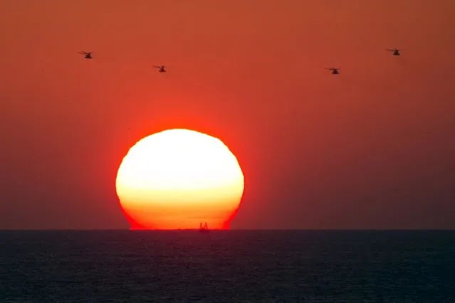 Four military helicopters fly over the Mediterranean sea opposite the port of Ashdod, Israel June 29, 2015. Israel said on Monday it had blocked a boat leading a four-vessel protest flotilla of foreign activists from reaching the Gaza Strip and forced the vessel to sail to the Israeli port in Ashdod. (Photo by Amir Cohen/Reuters)