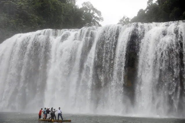 Philippine Environment department staff ride on a raft as they inspect Tinuy-an Waterfalls in Bislig, Surigao del Sur in southern Philippines February 15, 2017. (Photo by Erik De Castro/Reuters)