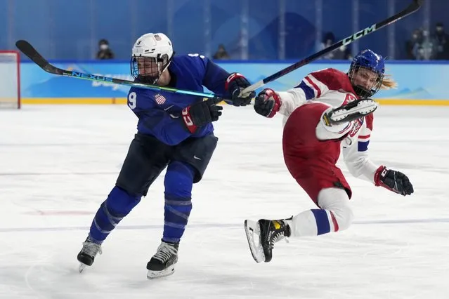 Czech Republic's Daniela Pejsova, right, falls next to United States' Megan Bozek (9) during a women's quarterfinal hockey game at the 2022 Winter Olympics, Friday, February 11, 2022, in Beijing. (Photo by Petr David Josek/AP Photo)