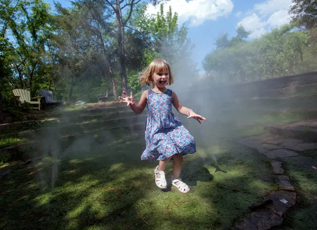 Philippa Going, 3, laughs as she runs through the Into the Mist exhibit at the Museum of Life and Science on Wednesday, May 4, 2016 in Durham, N.C. (Photo by Kaitlin McKeown/The Herald-Sun via AP Photo)