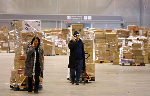 Volunteers in a warehouse near Berlin's BER Berlin-Brandenburg Airport help prepare locally donated aid meant for earthquake victims in Turkey for shipment by air on February 09, 2023 in Schoenefeld, Germany. The local Turkish community in Berlin is rallying with a large-scale effort to send clothing, medicine, blankets, generators and other assistance to cities in southern Turkey devastated by the recent earthquake. (Photo by Sean Gallup/Getty Images)