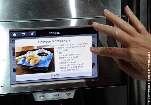 An attendee uses an interface on a refrigerator using LG's newest Smart ThinQ technology at the LG Electronics booth at the 2012 International Consumer Electronics Show