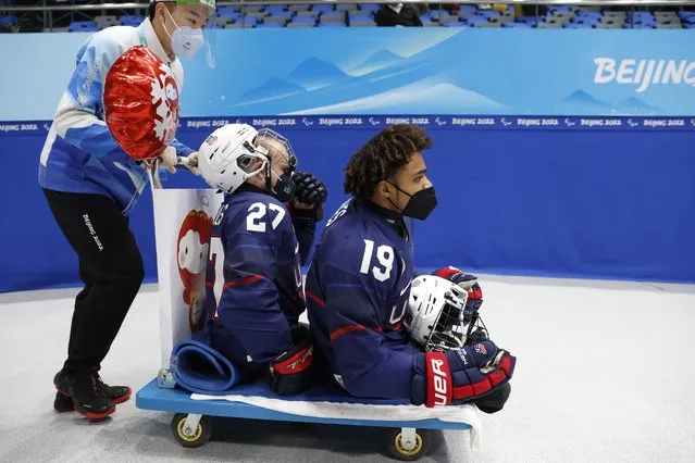 Josh Pauls and Rico Roman of the United States warm up before their ice hockey semi-final against China at the Winter Paralympics in Beijing on March 11, 2022. (Photo by Peter Cziborra/Reuters)