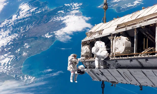 Mission Specialists Robert L. Curbeam, Jr (left) and Christer Fuglesang participate in the first of the mission’s three planned sessions of extravehicular activity as construction resumes on the International Space Station in 2008. (Photo by NASA)