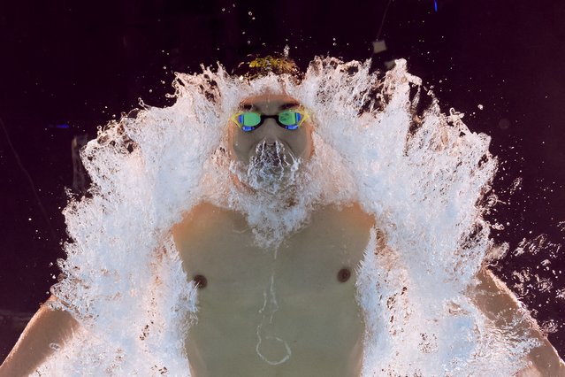 An underwater view shows Hungary's Kristof Milak competing in a heat of the men's 200m butterfly swimming event during the Paris 2024 Olympic Games at the Paris La Defense Arena in Nanterre, west of Paris, on July 30, 2024. (Photo by Oli Scarff/AFP Photo)