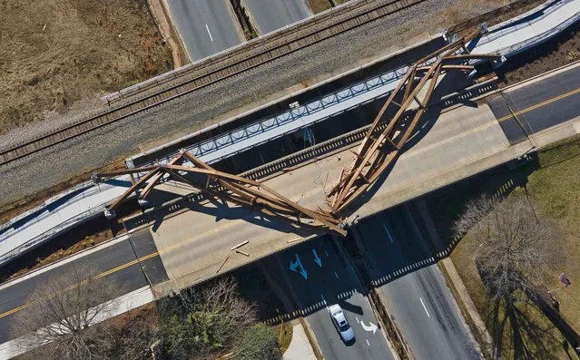 This aerial image take with a drone, shows collapsed wooden arches Friday morning, February 18, 2022, in Hickory. N.C. The arches are an artistic component of a pedestrian bridge named for former Hickory Mayor Wright, which itself is part of the City Walk. (Photo by Walt Unks/The Winston-Salem Journal via AP Photo)