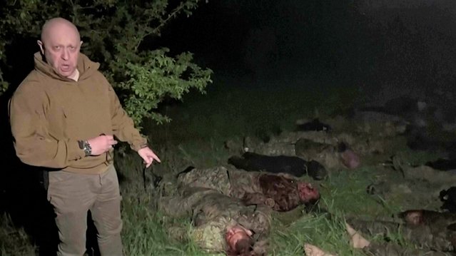 In this handout image taken from a video released by Prigozhin Press Service on Friday, May 5, 2023, head of Wagner Group Yevgeny Prigozhin stands in front of multiple bodies lying on the ground in an unknown location. The owner of Russia's private military company Wagner, Yevgeny Prigozhin, on Friday threatened to pull out Wagner forces from the embattled Ukrainian city of Bakhmut next week, accusing Russia's military command of starving the group of ammunition. (Photo by Prigozhin Press Service via AP Photo)