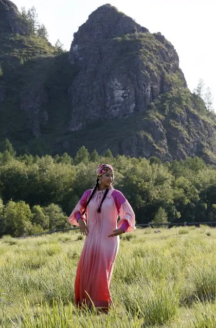 A model wearing a Khakas national dress performs during the reconstruction of daily life and traditional holidays celebrated by indigenous population of the Republic of Khakassia during a demonstration for visitors at a museum preserve outside Kazanovka village, southwest of the city of Abakan, Russia, July 24, 2015. (Photo by Ilya Naymushin/Reuters)