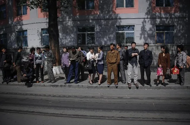 North Koreans wait in line for a city trolley, Monday, May 4, 2015 in Pyongyang, North Korea. The city trolley is one of the more common modes of public transportation used by commuters to get around the city. (Photo by Wong Maye-E/AP Photo)