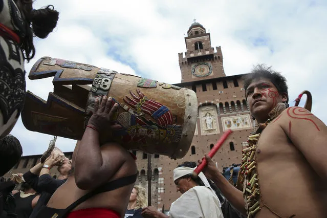 People belonging to indigenous tribes gather in front of the Sforza Castle, during “Lo spirito del Pianeta” (The Spirit of the Planet) International Festival of Indigenous Peoples, in Milan, Italy, Wednesday, June 1, 2016. (Photo by Luca Bruno/AP Photo)