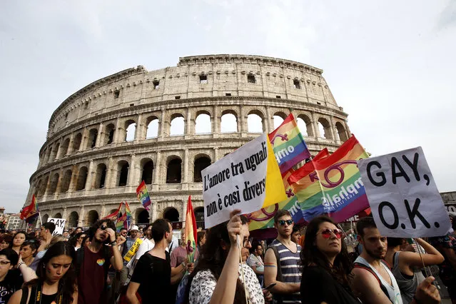People march past the Colosseum during the Gay Pride parade in Rome, Saturday, June 11, 2016. (Photo by Fabio Frustaci/AP Photo)