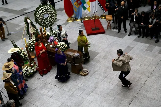 A man performs the “Cueca”, a national folk dance, in front of the casket of Chilean folk singer Margot Loyola at a museum in Santiago, August 4, 2015. Margot, a folk singer, songwriter, guitarist, pianist and researcher of Chilean folklore, died at the age of 96, according to local media. (Photo by Ivan Alvarado/Reuters)