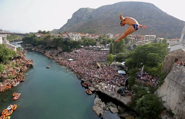 A competitor jumps from the Old Bridge during Red Bull Cliff Diving Competition in Mostar, Bosnia and Herzegovina on August 15, 2015. (Photo by Dado Ruvic/Reuters)