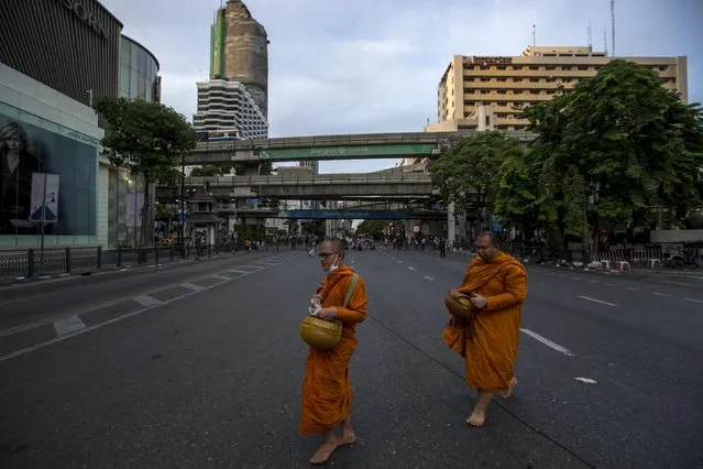 Thai Buddhist monks walk past near the scene of a blast in central Bangkok August 18, 2015. (Photo by Athit Perawongmetha/Reuters)