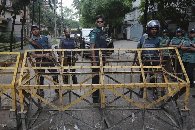 Bangladeshi policemen stand guard at a barricade leading to Holey Artisan Bakery in Dhaka's Gulshan area, Bangladesh, Sunday, July 3, 2016. The assault on the restaurant in Dhaka's diplomatic zone by militants who took dozens of people hostage marks an escalation in militant violence in the Muslim-majority nation. (Photo by AP Photo)