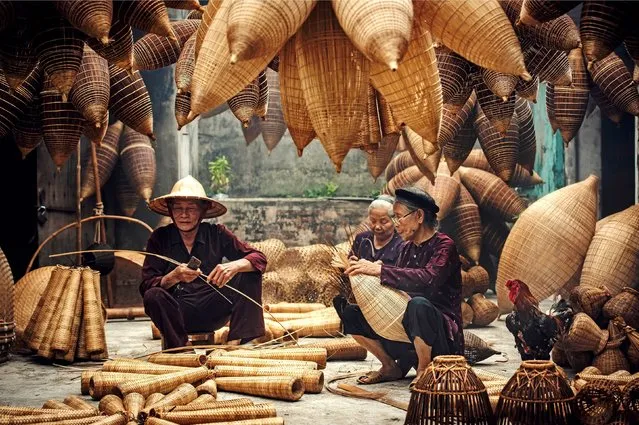 Workers intricately weave bamboo to create large fishing traps at the Vietnamese capital of Hanoi on June 7, 2022. The traps can each take up to three hours to make, and these skilled workers have honed their craft over many years. (Photo by Chanwit Wanset/Solent News & Photo Agency)