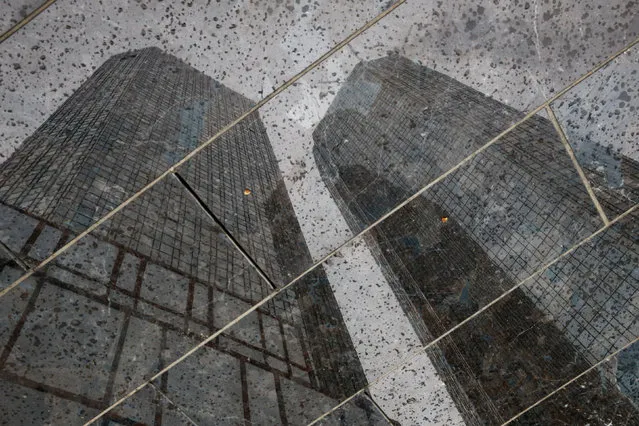 The headquarters of the Deutsche Bank are reflected in the polished floor, in Frankfurt, Germany, April 27, 2015. (Photo by Kai Pfaffenbach/Reuters)
