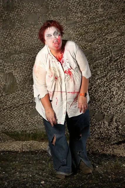 A visitor to the Shocktober Fest dressed as a zombie poses on October 6, 2012 in Turners Hill, England. People dressed as zombies from around the United Kingdom have converged on Tulleys Farm in an attempt to set a new Guinness World Record for the most zombies together in one place.  (Photo by Peter Macdiarmid)