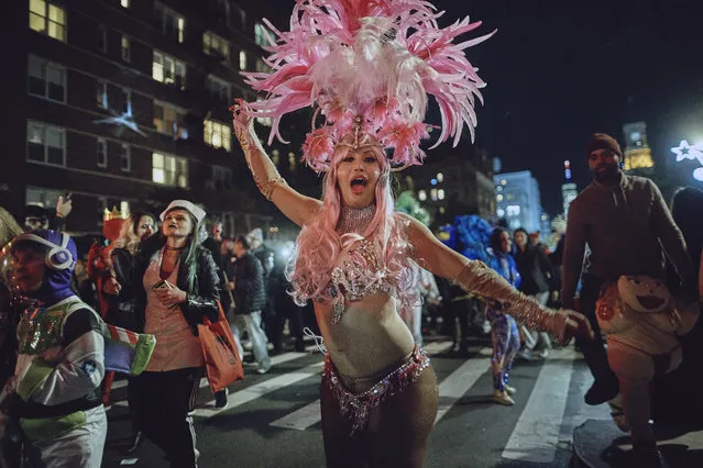 Revelers march during the Greenwich Village Halloween Parade, Tuesday, October 31, 2017, in New York. (Photo by Andres Kudacki/AP Photo)