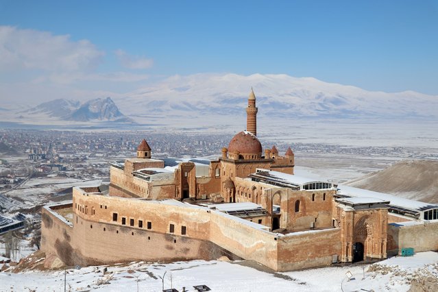 A general view of the snow covered Ishak Pasha Palace, one of the most important monuments built by the Ottomans in Anatolia, after snowfall in Agri, Turkiye on February 15, 2025. Snow covered palace and its surroundings, along with its historical structure and natural beauties in the region, attract attention in the winter season. (Photo by Abdullah Soylemez/Anadolu via Getty Images)